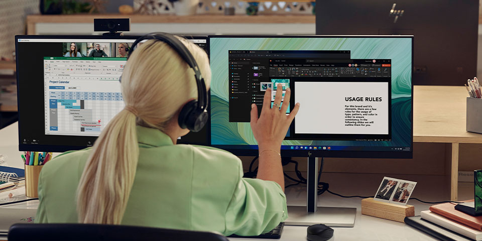 Woman working on dual screen