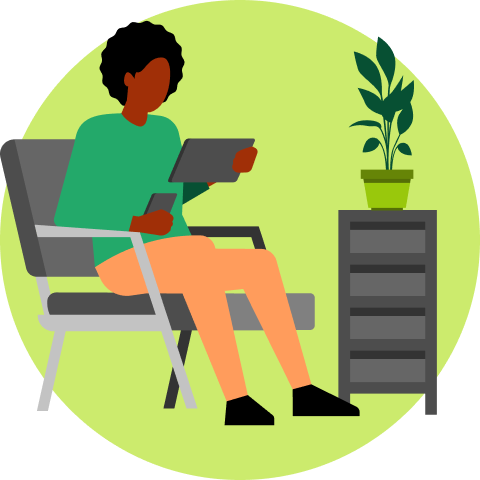 Person sitting relaxed on chair using tablet and smartphone in modern living space with plant