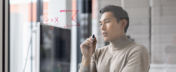 A man wrote a formula on the board and thinks