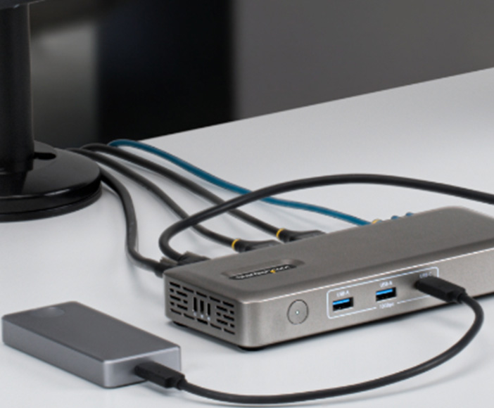 External StarTech docking station with multiple USB ports and connected storage device on desk