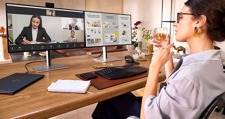 Woman sitting at a Desk with HP Monitors