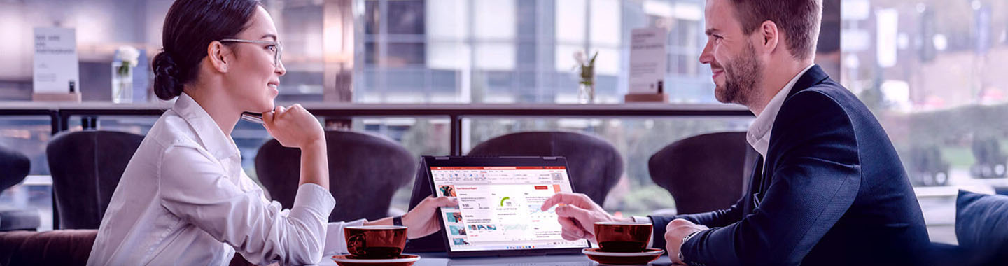 A woman and a man at a table in the office