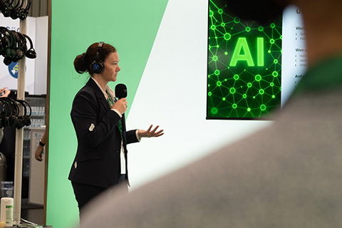 A speaker is giving a talk on AI.