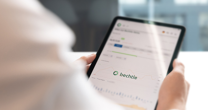 Man holding an iPad with a stock chart on it