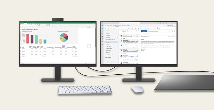 Dual monitor desk setup with office and analytics applications