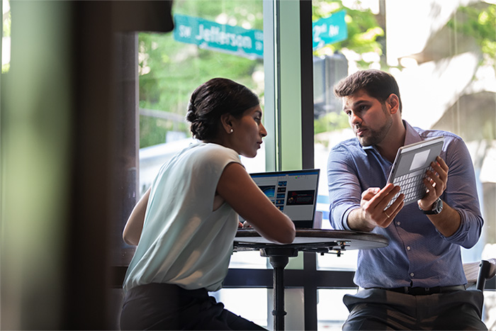 Qualcomm Two People Meeting with Mobile Devices