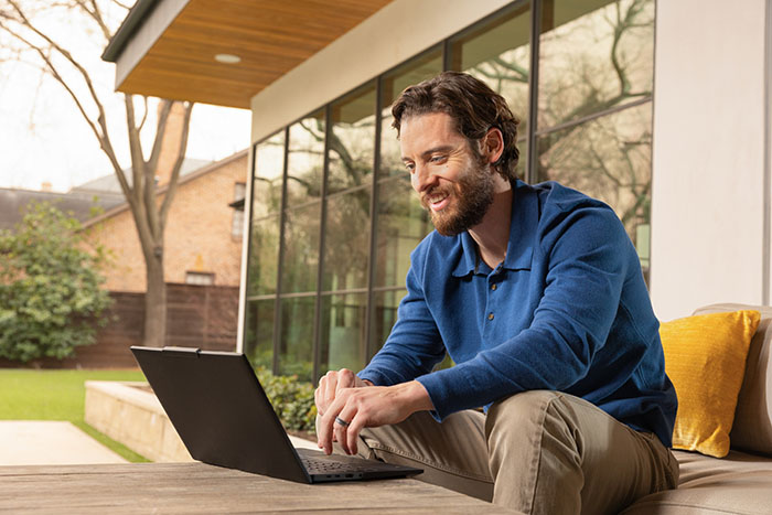 Qualcomm Man sitting in home patio with Mobile Devices