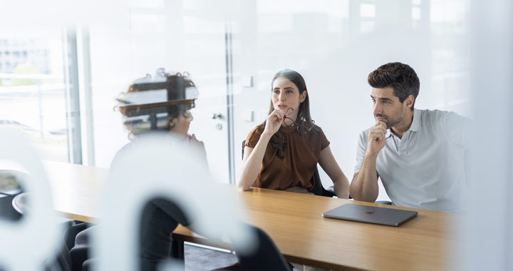 Two people are sitting in a conference room