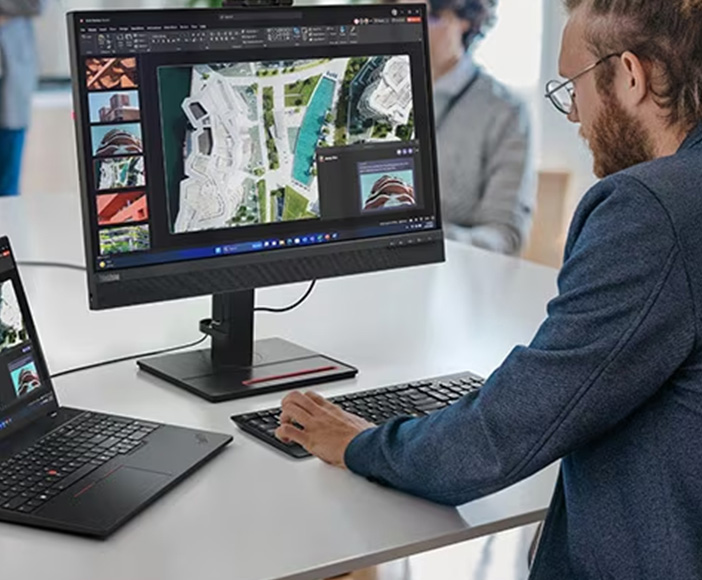 Man working on Lenovo computer in modern office environment