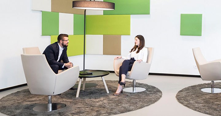A woman and a man sitting on armchairs