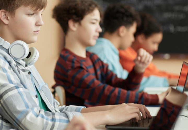 Kids in school working on laptops