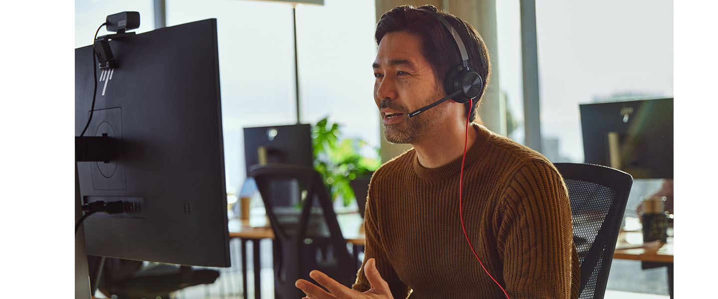 Man working in the office, using Blackwire Headset