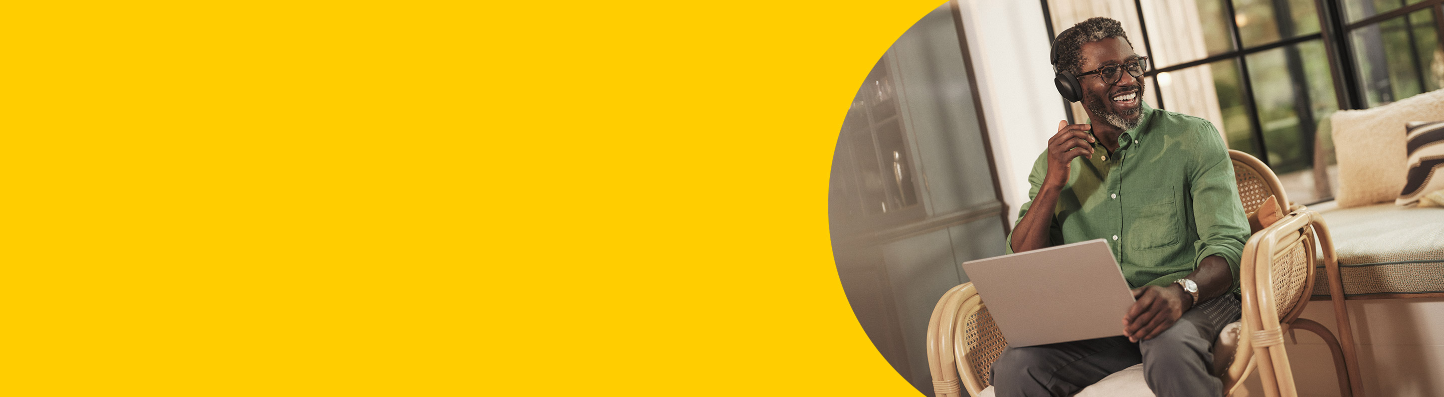 Jabra Evolve3 series. Man working while sitting on the sofa & phoning with his headset from Jabra.