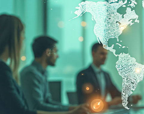 People in modern office setting engaged in discussion with digital world map symbolizing global connectivity