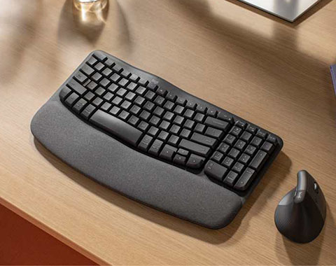 Ergonomic keyboard with wrist rest and vertical mouse on desk for comfortable working