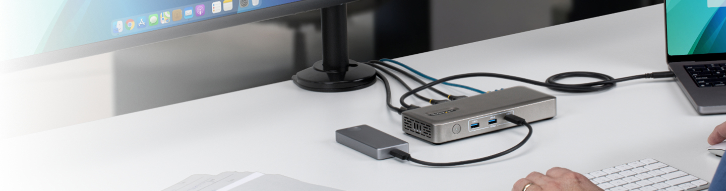 External StarTech docking station with multiple USB ports and connected storage device on desk