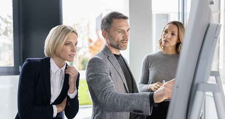 Meeting analyzing data on a board