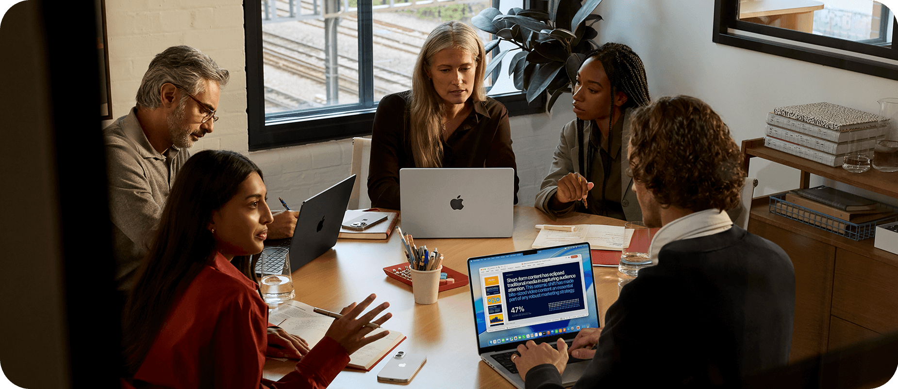 Apple MacBook Pro M5. Creative woman working at desk.