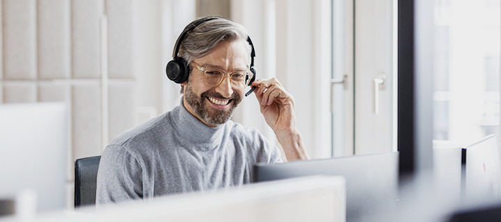 A happy man is working in a call center