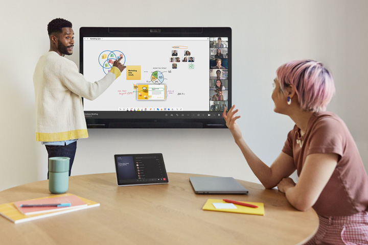Two people meeting and using a Cisco Board Pro G3