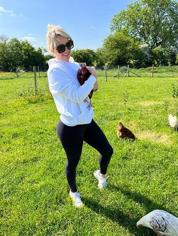 Woman holding a chicken