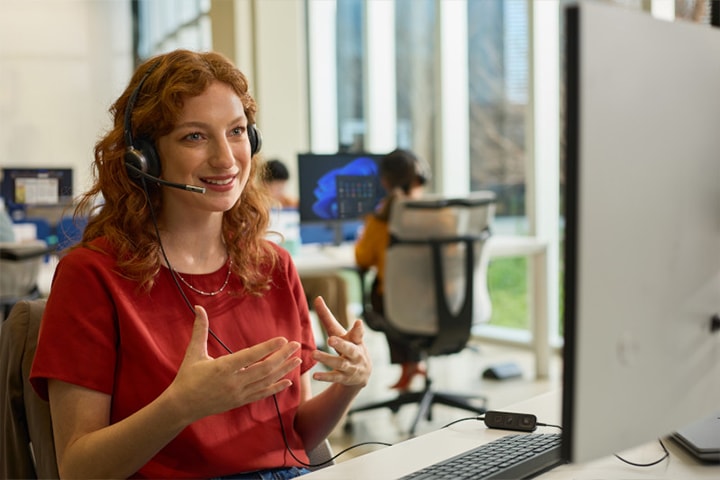 Customer support agent wearing headset in modern office environment