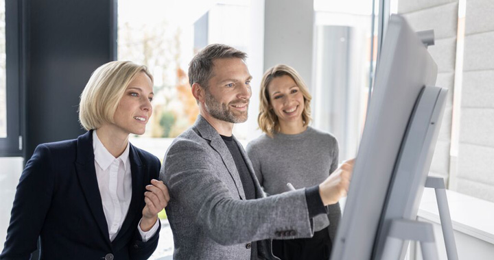 Man and women analysing on the board