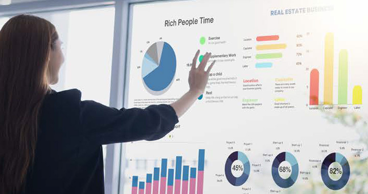A woman is looking at data and charts