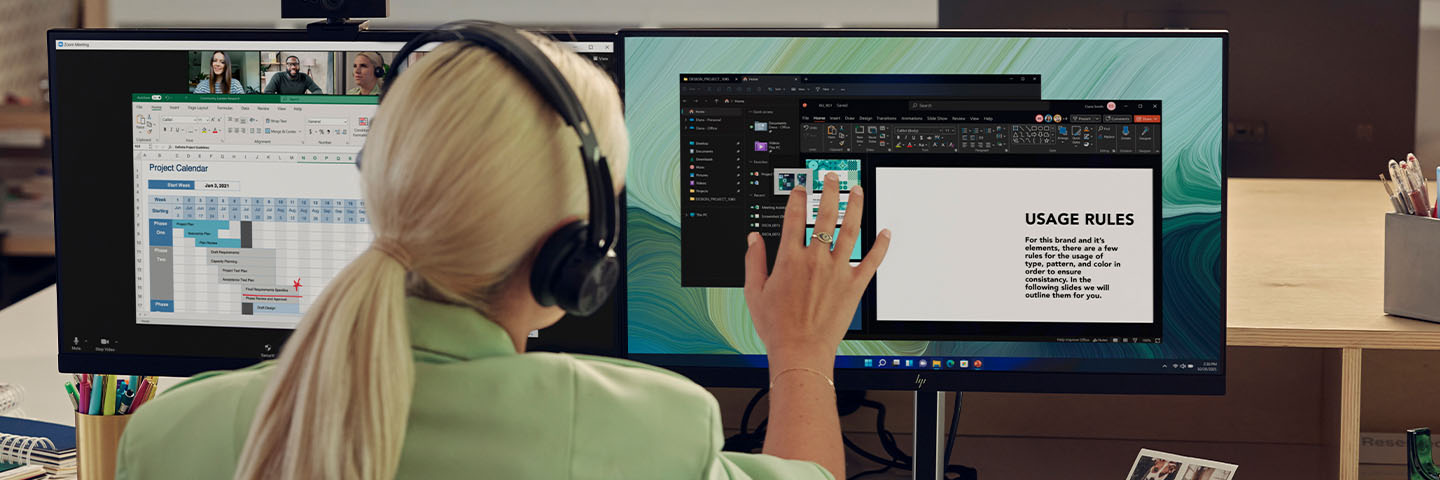 Woman working on dualscreen