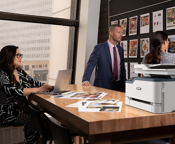 Two women and a man in the office