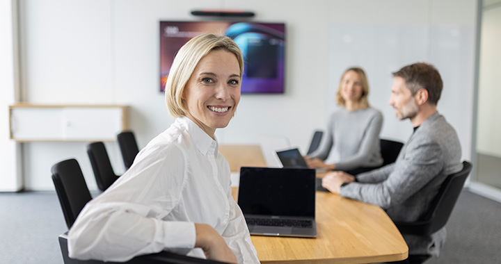 Three persons meeting in a room