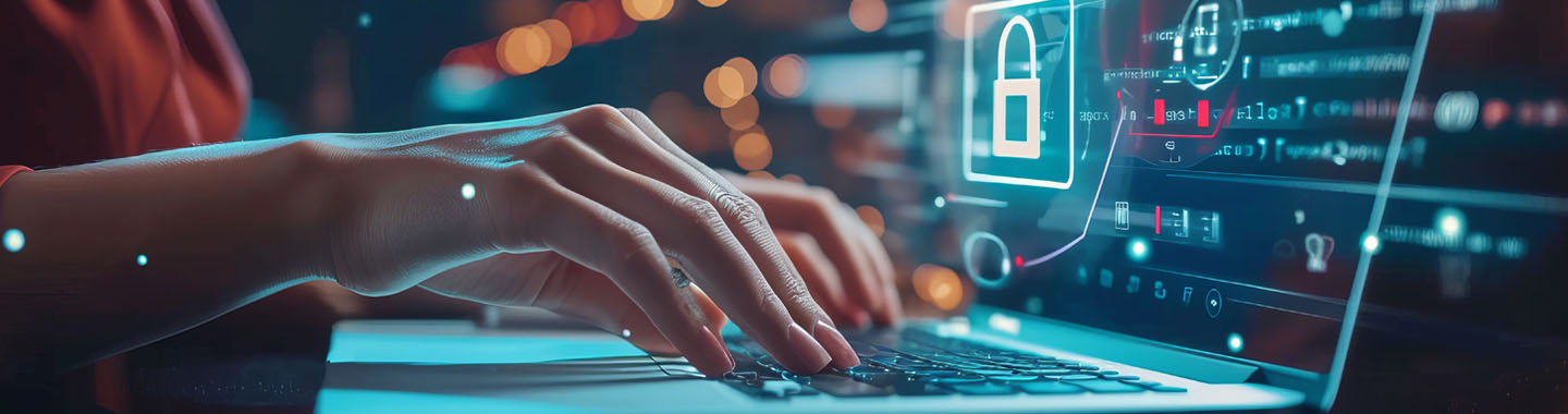 Close-up of hands on a notebook, with a lock symbol on the monitor