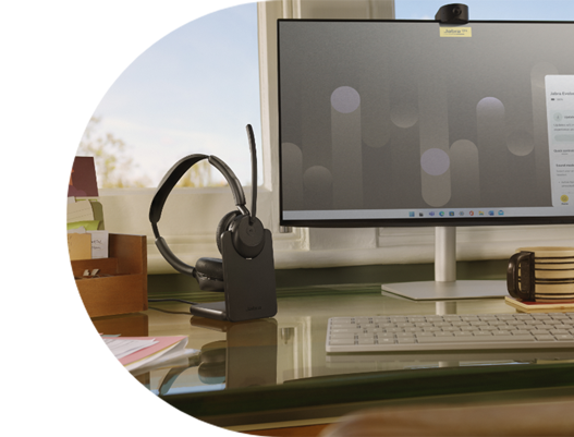 Jabra Evolve3 45: Workstation with monitor, Jabra headset on charging dock, keyboard, and accessories.