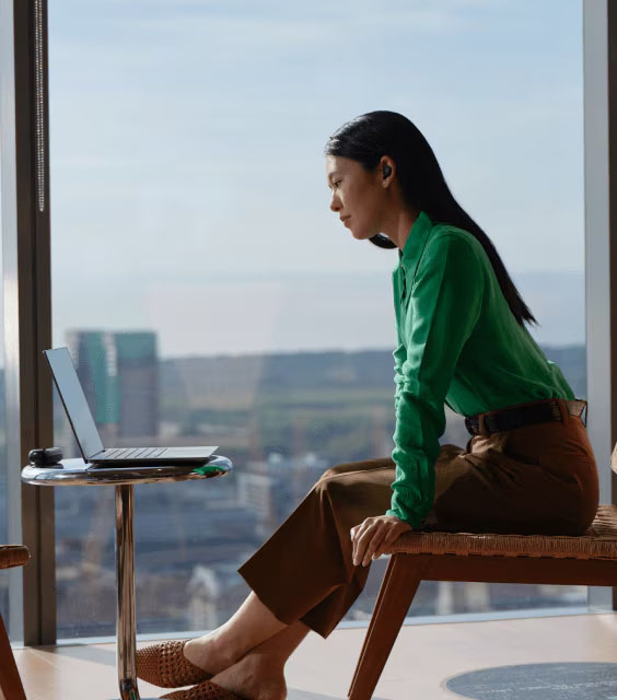 Feel secure | Woman sitting in front of notebook