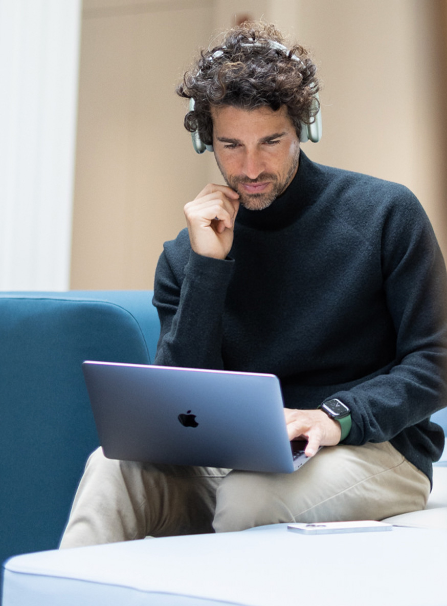 Apple Professional Services. Man working on a MacBook in the office.