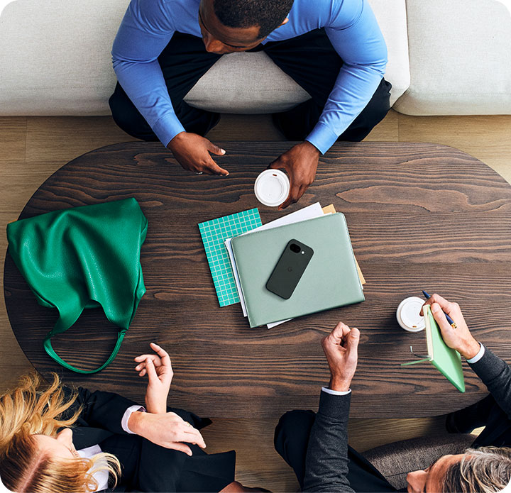 three people sitting around a table