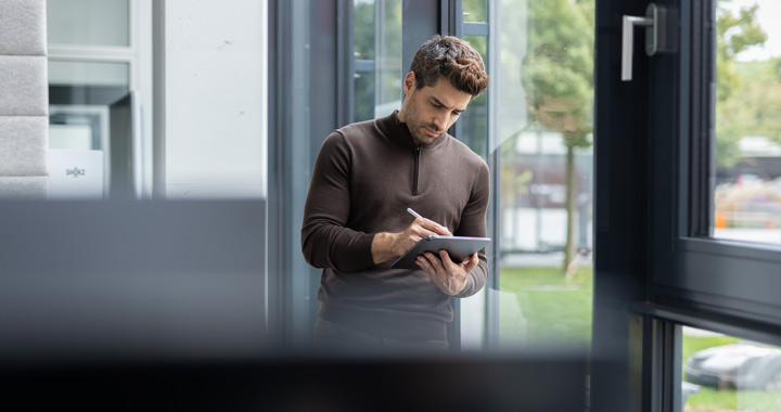 Man writing on a tablet