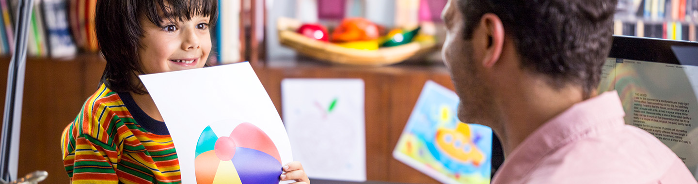 Child shows a colourful printout