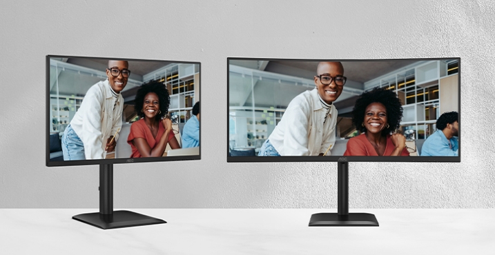 Dual monitor setup on modern desk displaying business video content