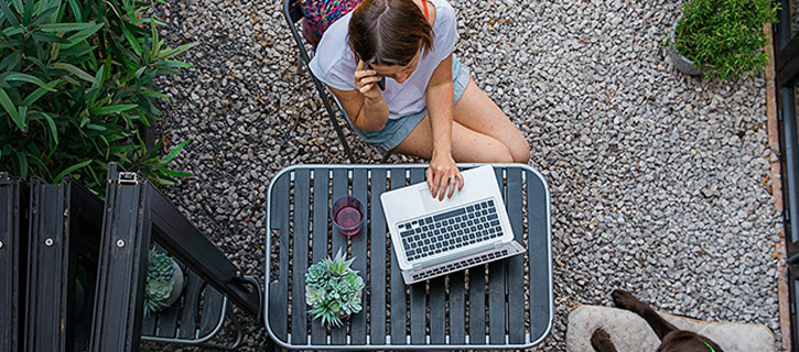 A woman is working on a laptop