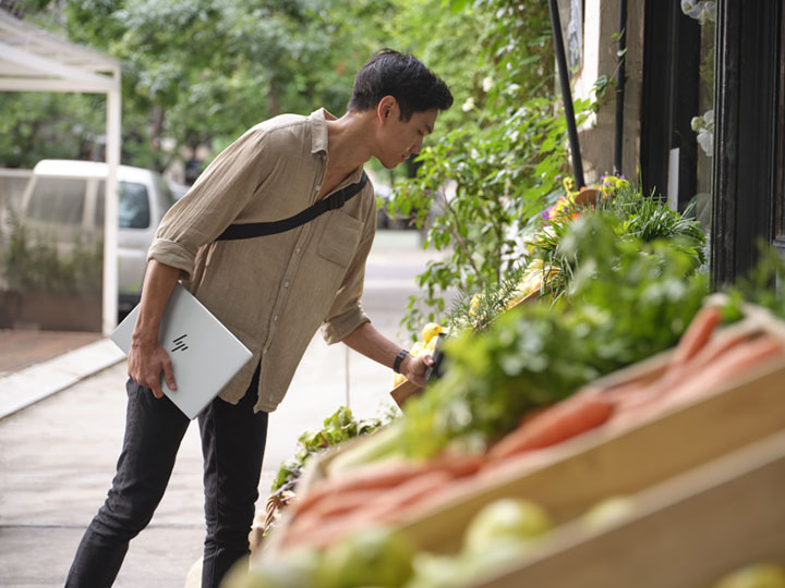 Man looking at herbs on a street store