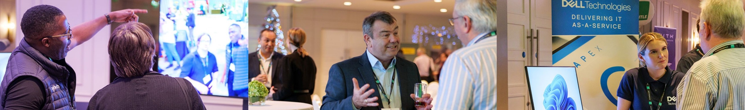 People engaged in conversation at an IT conference with presentation and Dell Technologies booth