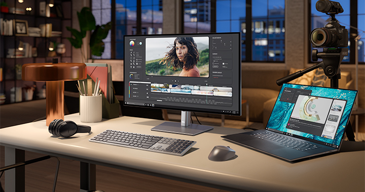 Working desk setup in a warm low light office environment.