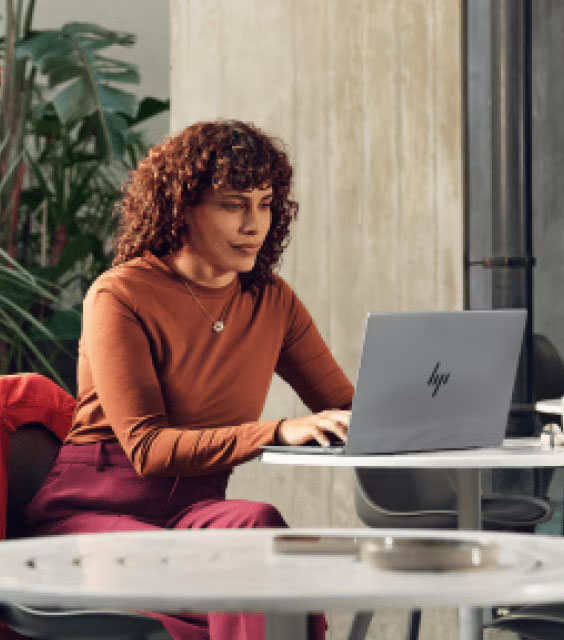 Amplify your potential | Woman sitting in front of laptop