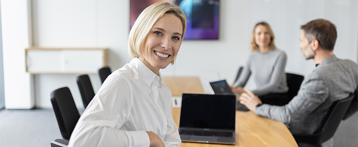 A woman in the office smiles