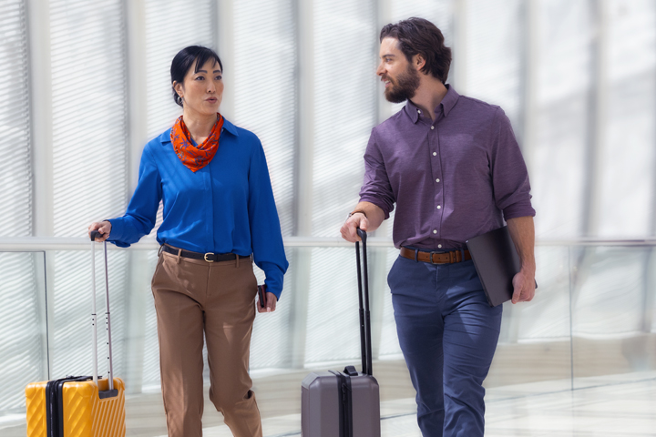 Business workers traveling with lugage and laptop.