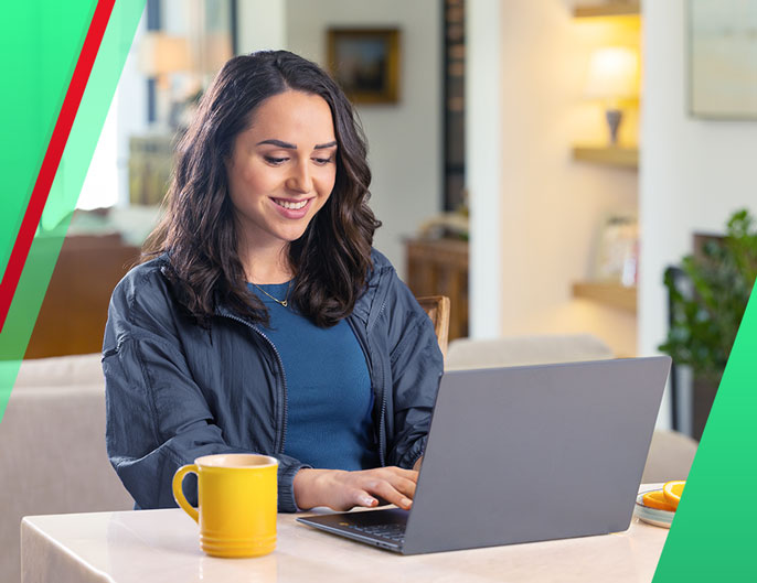 Woman sitting in a coffee in front of a laptop