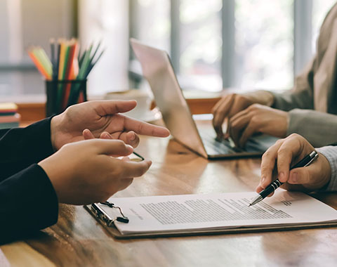 Business people sitting in a meeting room with a contract