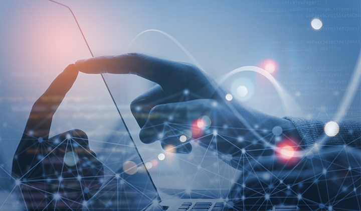 A man is typing on a laptop