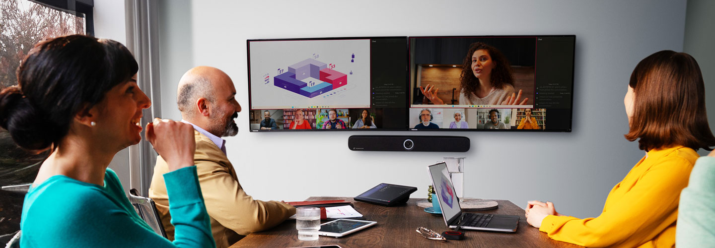 People in a meeting room with a screen